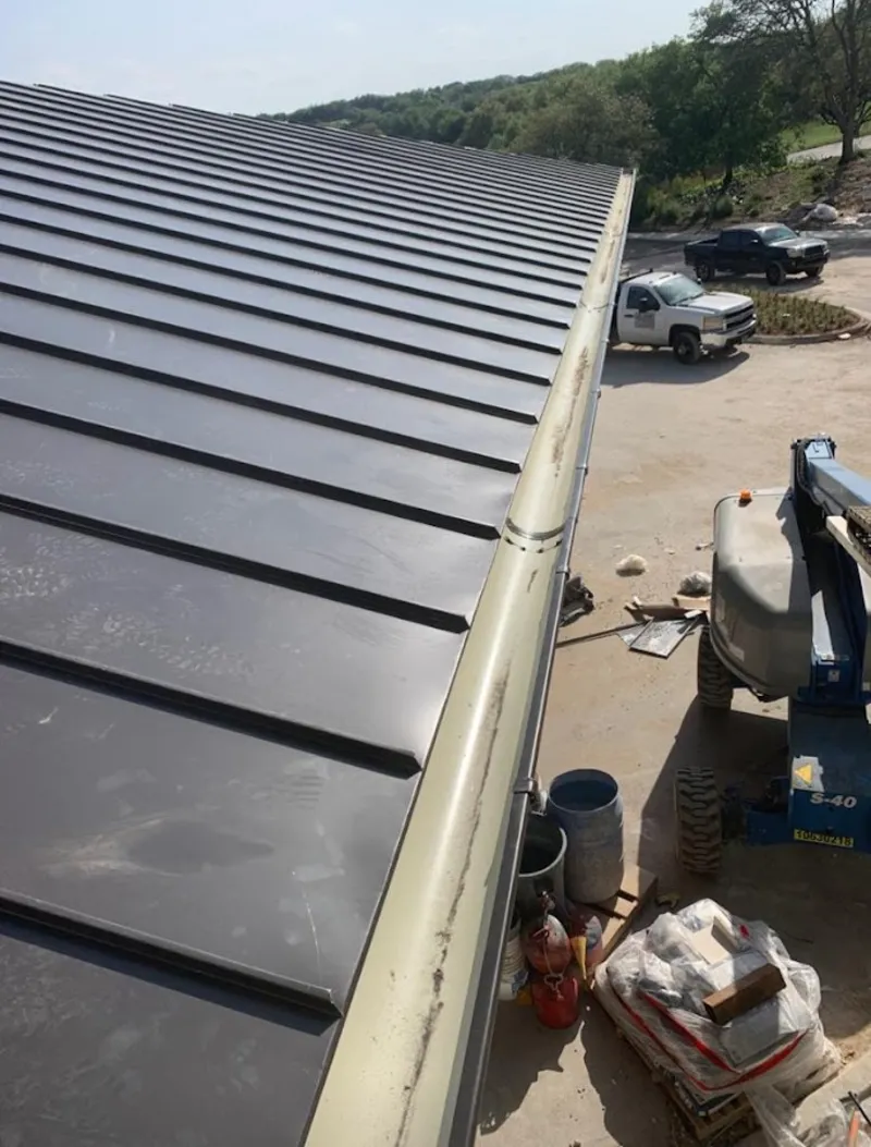 Standing seam panel and gutter detail on a metal roofing jobsite in Cumberland